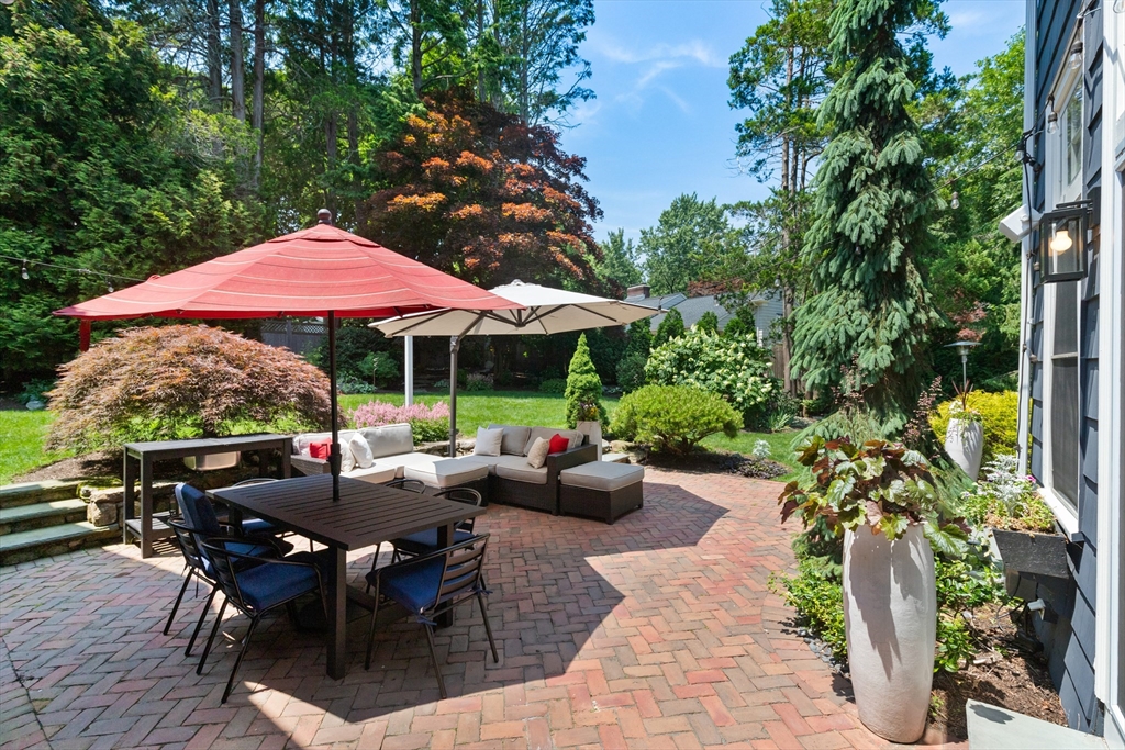 17 Swan Road Winchester, MA 01890 - Photo 39 of 41 a view of a patio with chairs potted plants and a large tree