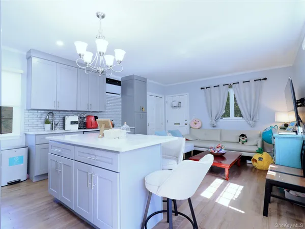 a dining room with stainless steel appliances kitchen island a table and chairs in it