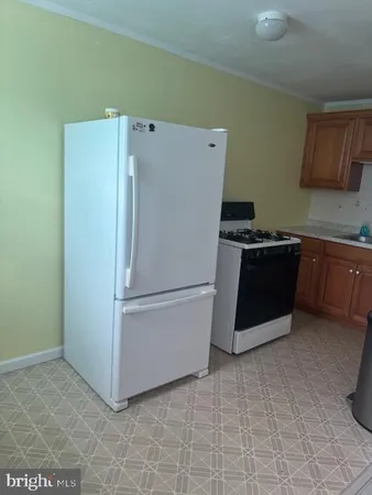 a white refrigerator freezer sitting in a kitchen