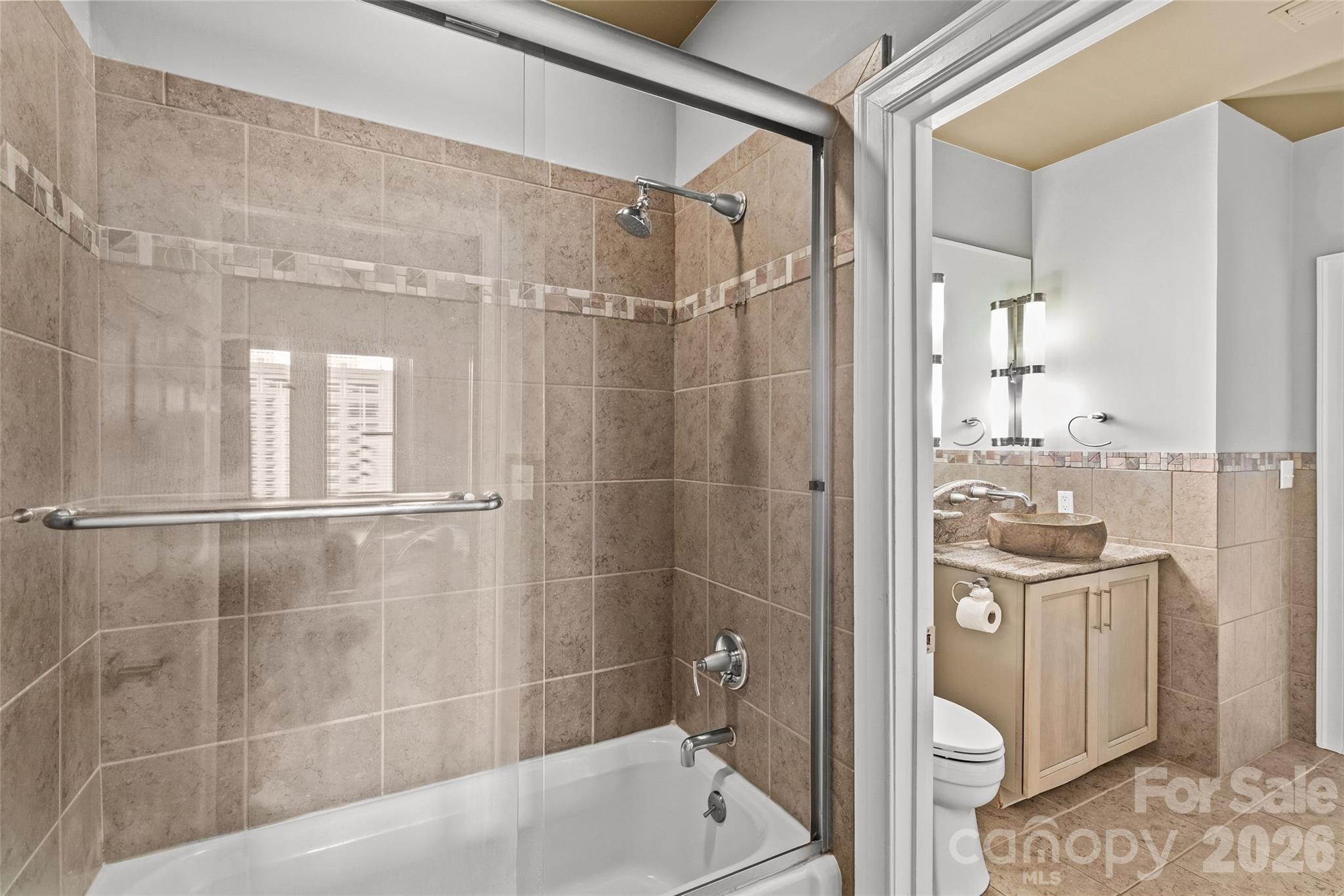 127 North Tryon Street, Unit 410 Charlotte, NC 28246 - Photo 15 of 37 a bathroom with a shower and a sink