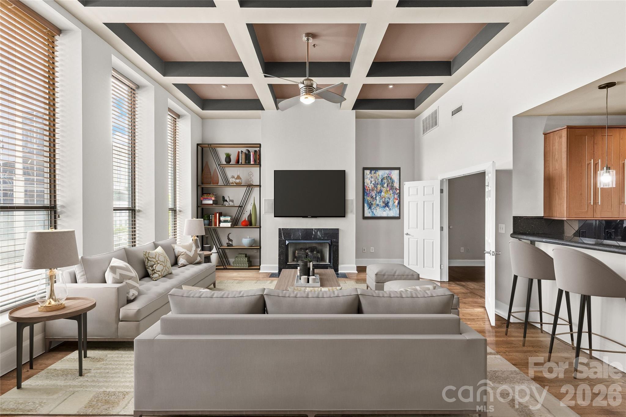 127 North Tryon Street, Unit 410 Charlotte, NC 28246 - Photo 20 of 37 a living room with fireplace furniture and a flat screen tv