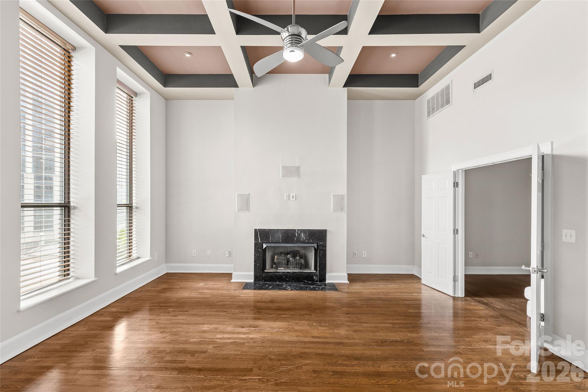 127 North Tryon Street, Unit 410 Charlotte, NC 28246 - Photo 22 of 37 a view of an empty room with a fireplace and a window