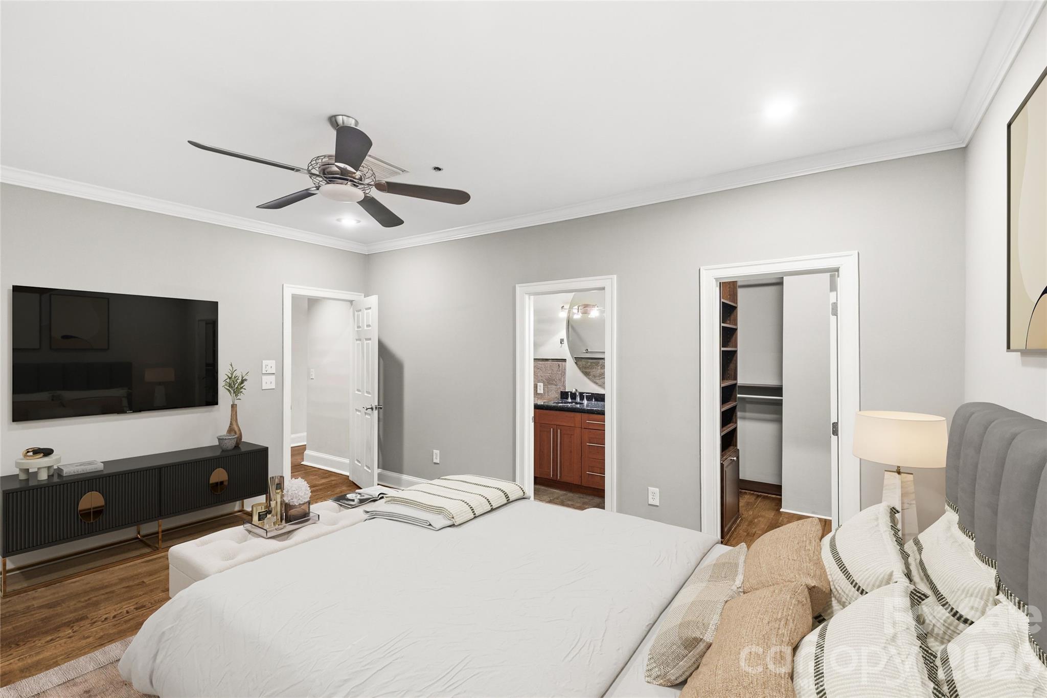 127 North Tryon Street, Unit 410 Charlotte, NC 28246 - Photo 10 of 37 a bedroom with a bed and a flat screen tv