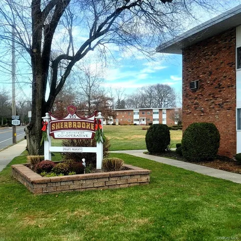 a view of a chair and table in the garden