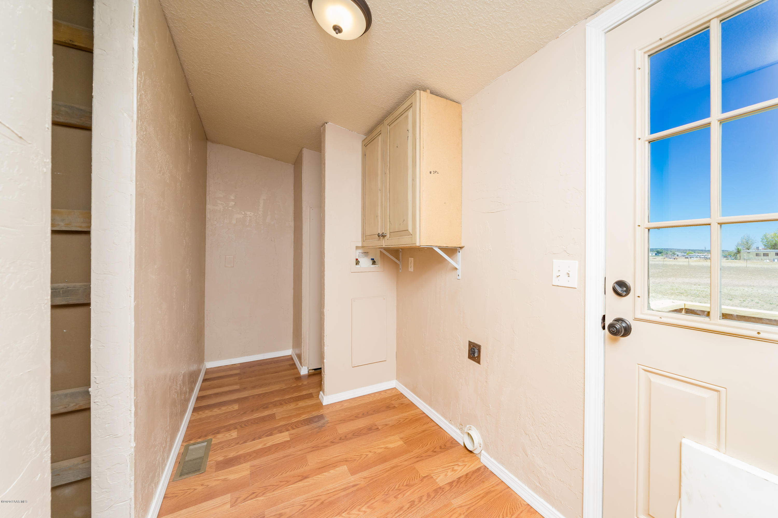 25125 North Mitchell Road Paulden, AZ 86334 - Photo 14 of 18 a view of a hallway with wooden floor and staircase