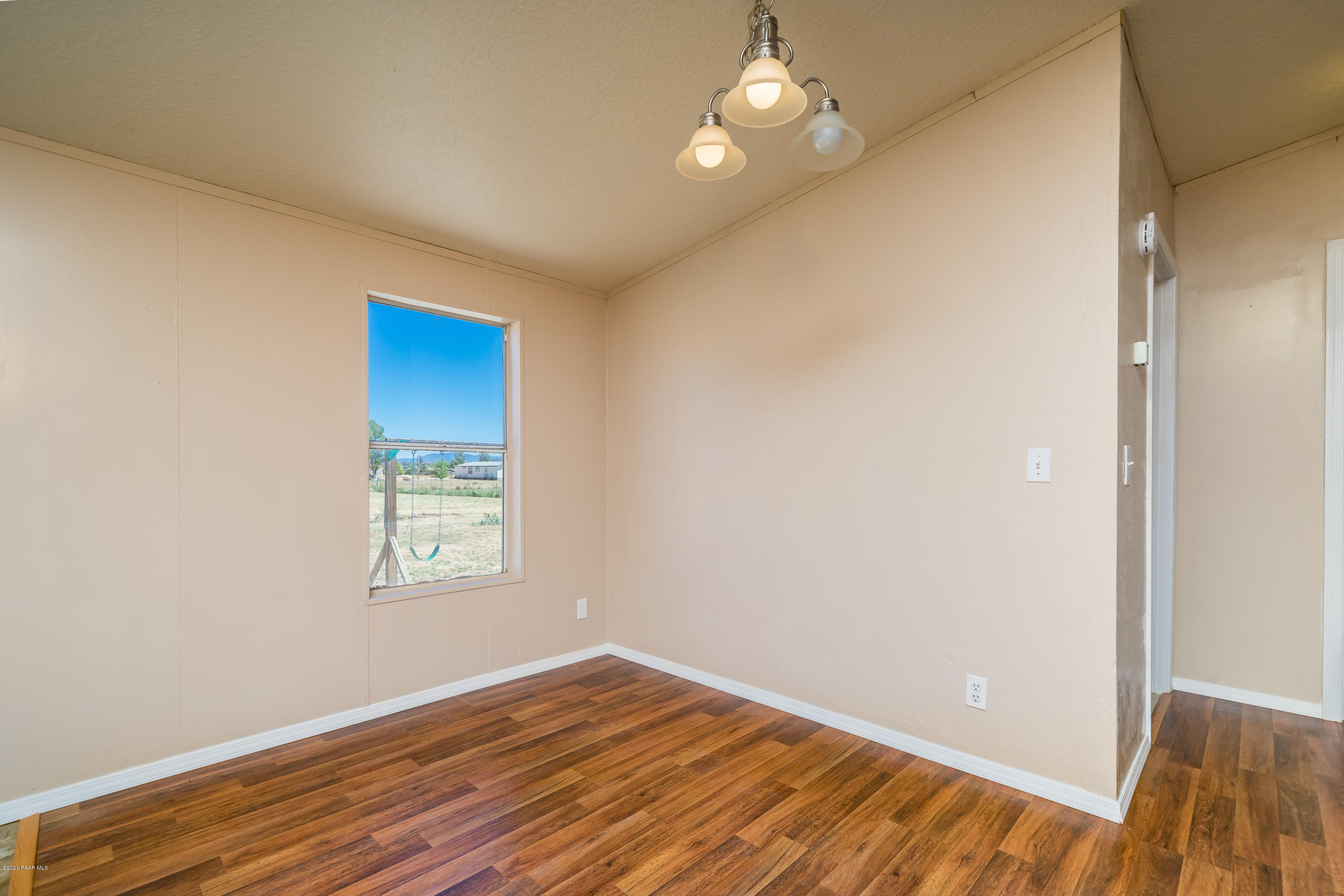 25125 North Mitchell Road Paulden, AZ 86334 - Photo 6 of 18 an empty room with wooden floor closet and windows