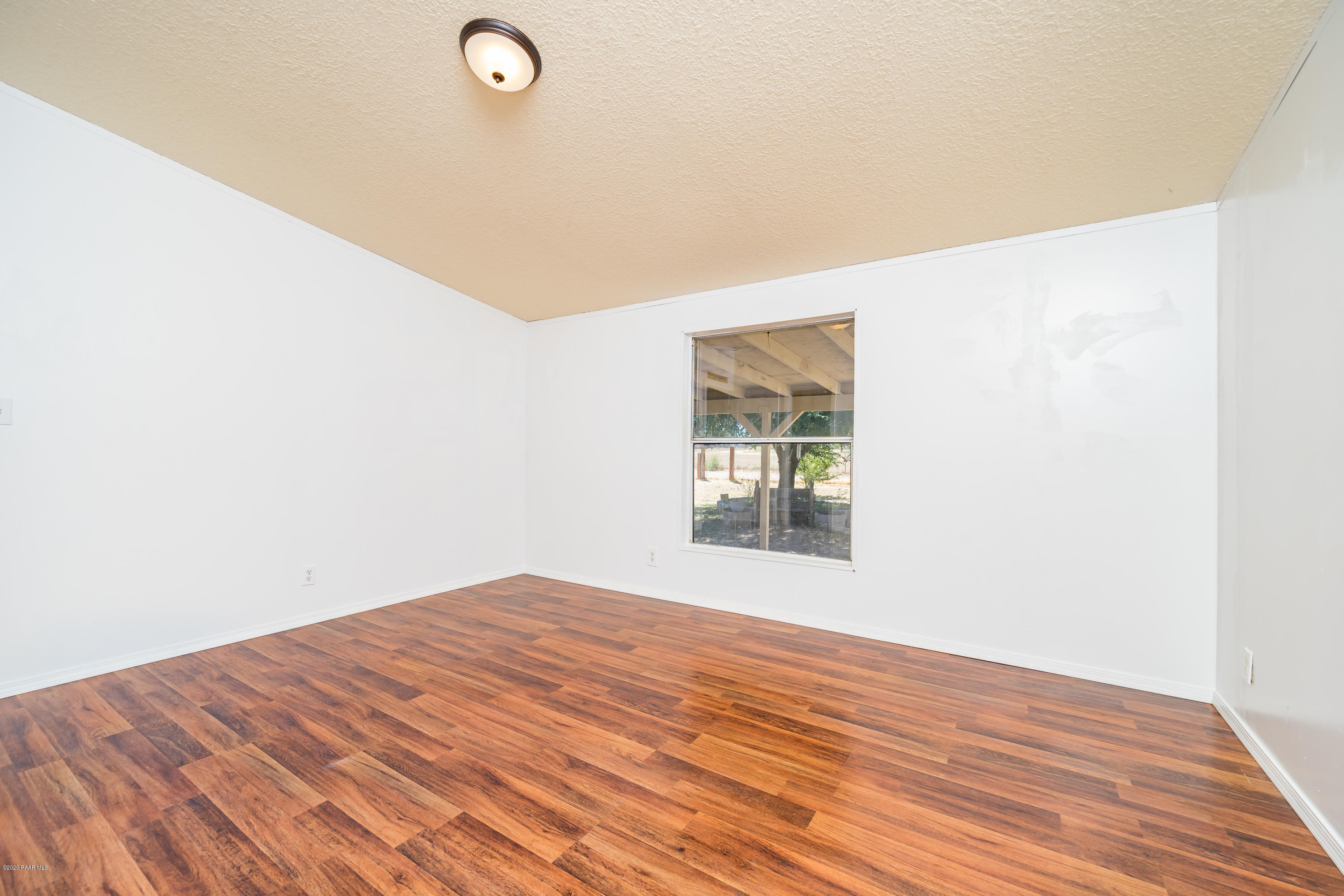25125 North Mitchell Road Paulden, AZ 86334 - Photo 8 of 18 a view of empty room with wooden floor and fan