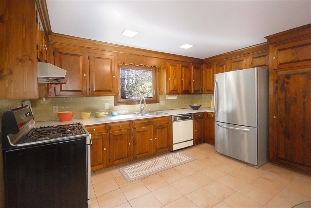 1 Pomfret Road Chelmsford, MA 01824 - Photo 11 of 28 a kitchen with stainless steel appliances granite countertop a refrigerator stove and sink