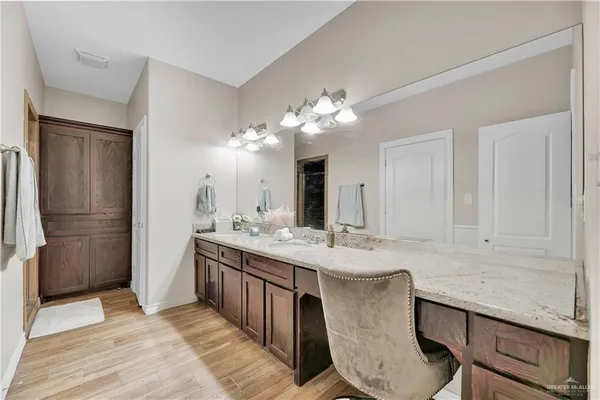 a kitchen with kitchen island granite countertop a sink cabinets and stainless steel appliances