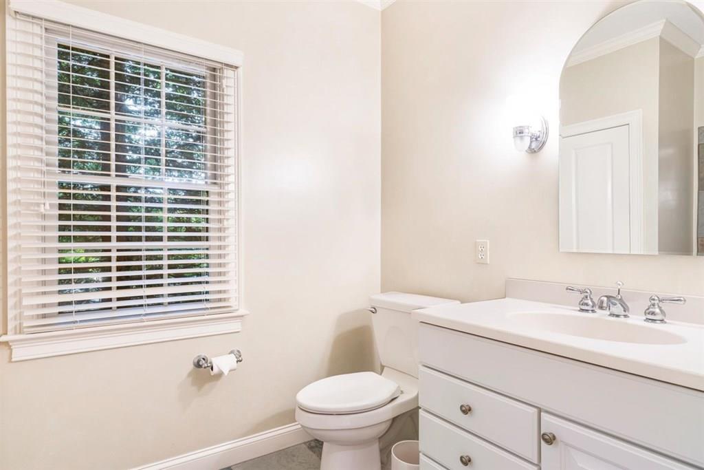 21 Hayden Ridge Plymouth, MA 02360 - Photo 19 of 34 a bathroom with a granite countertop toilet a sink a mirror and a window
