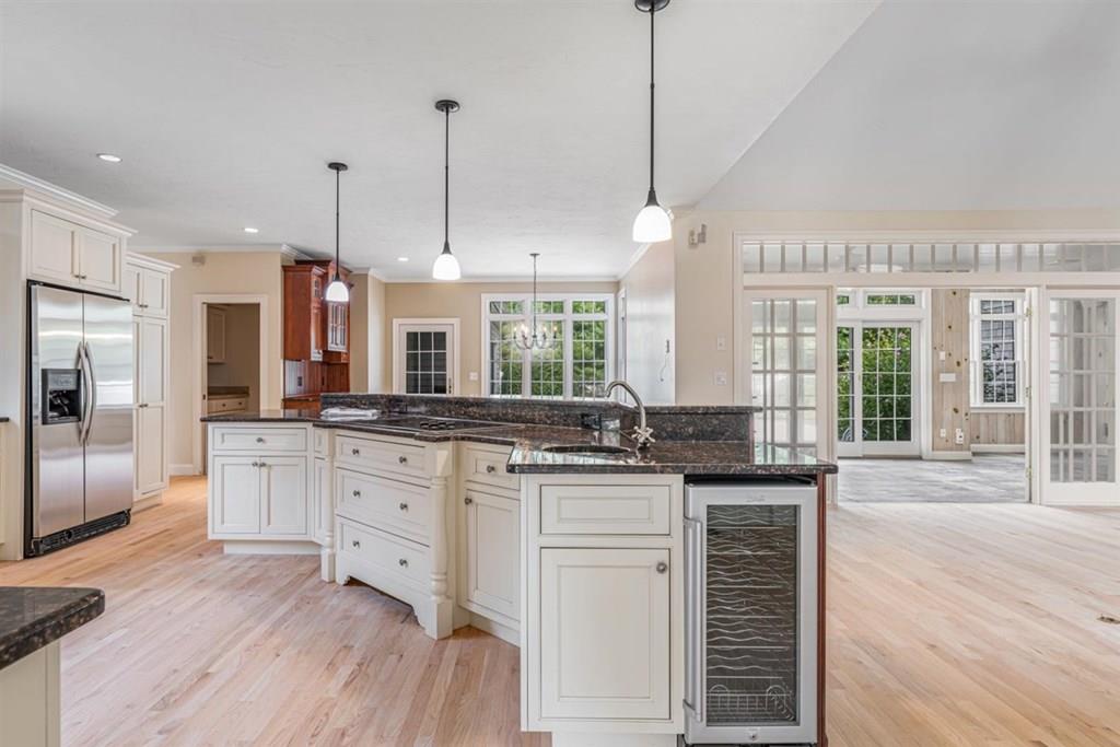 21 Hayden Ridge Plymouth, MA 02360 - Photo 27 of 34 a kitchen with stainless steel appliances granite countertop a stove a sink a refrigerator and white cabinets with wooden floor