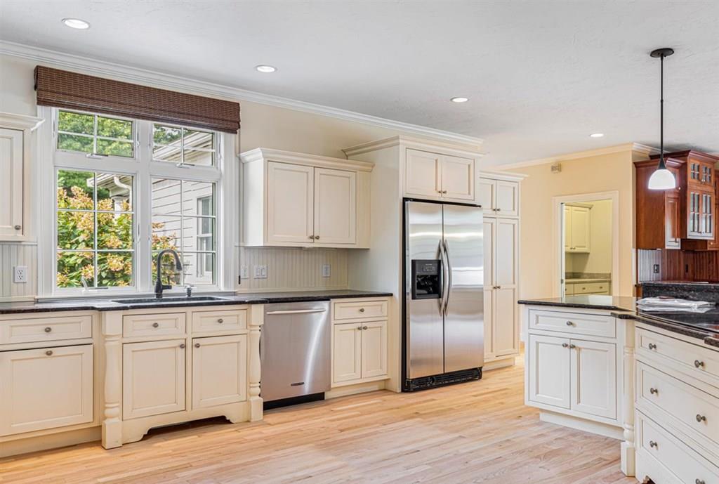 21 Hayden Ridge Plymouth, MA 02360 - Photo 4 of 34 a kitchen with stainless steel appliances granite countertop a refrigerator a sink and white cabinets with wooden floor