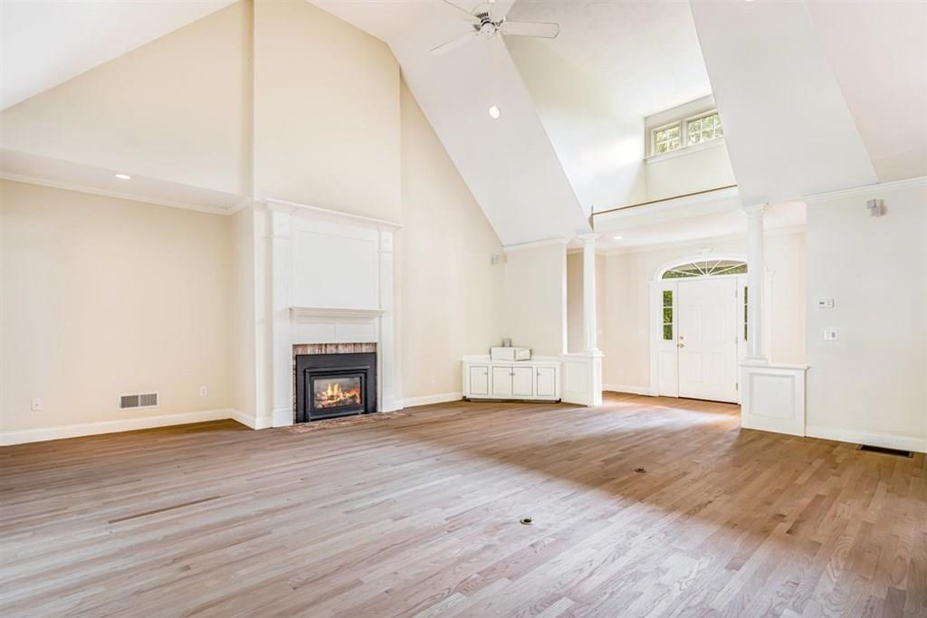 21 Hayden Ridge Plymouth, MA 02360 - Photo 7 of 34 an empty room with wooden floor and fireplace