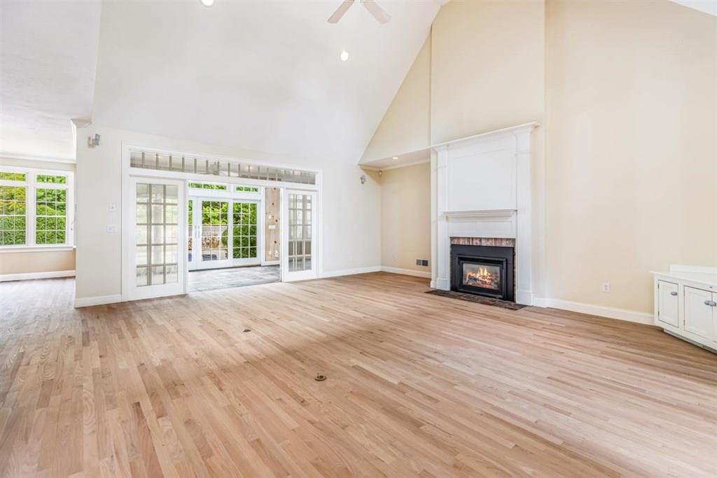21 Hayden Ridge Plymouth, MA 02360 - Photo 10 of 34 an empty room with wooden floor fireplace and windows