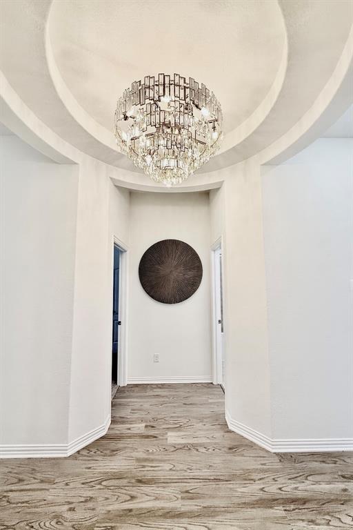 1336 Morning View Road Georgetown, TX 78628 - Photo 6 of 40 A dazzling crystal chandelier illuminates the sophisticated arched entryway and wood-look flooring.
