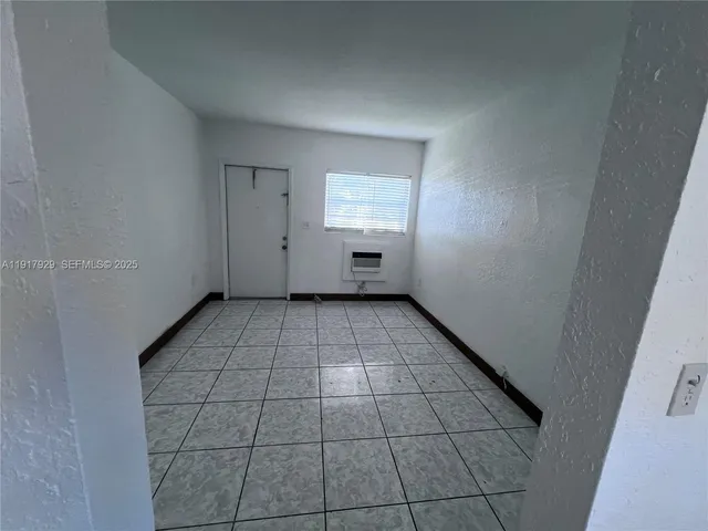 a view of a livingroom with an empty space and window