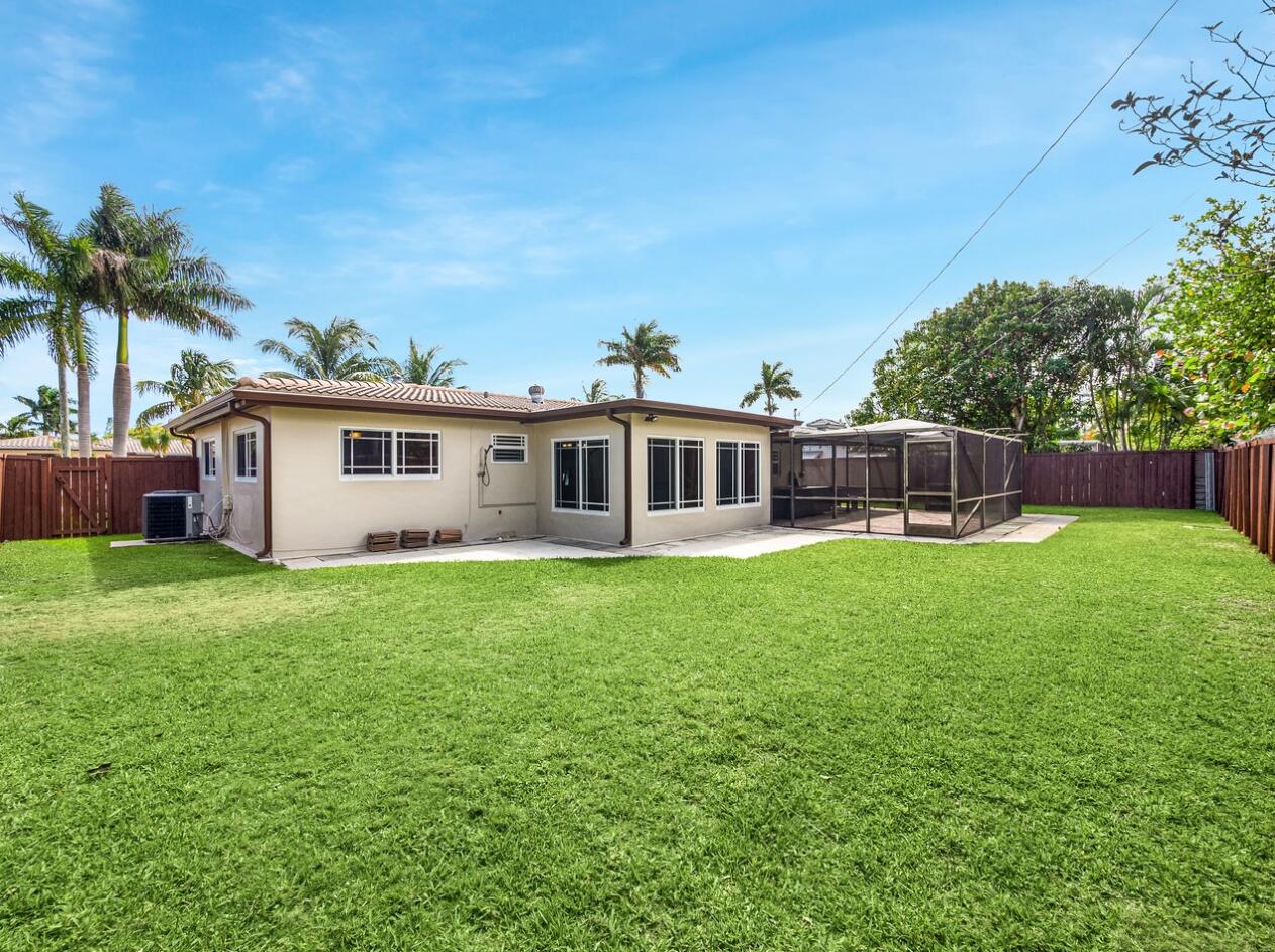 355 Northeast 24th Street Boca Raton, FL 33431 - Photo 13 of 15 a front view of house with yard and outdoor seating