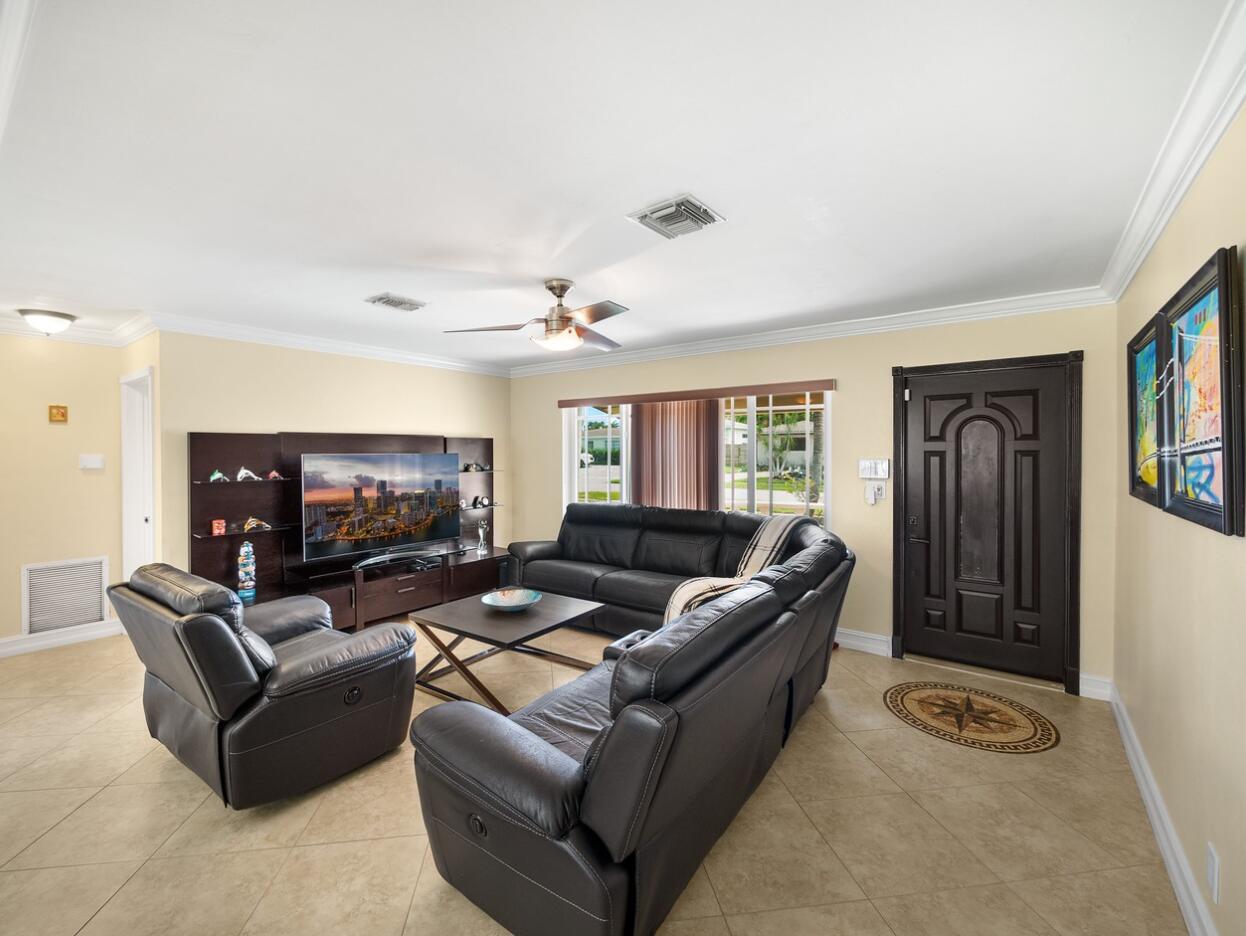 355 Northeast 24th Street Boca Raton, FL 33431 - Photo 2 of 15 a living room with furniture and a flat screen tv