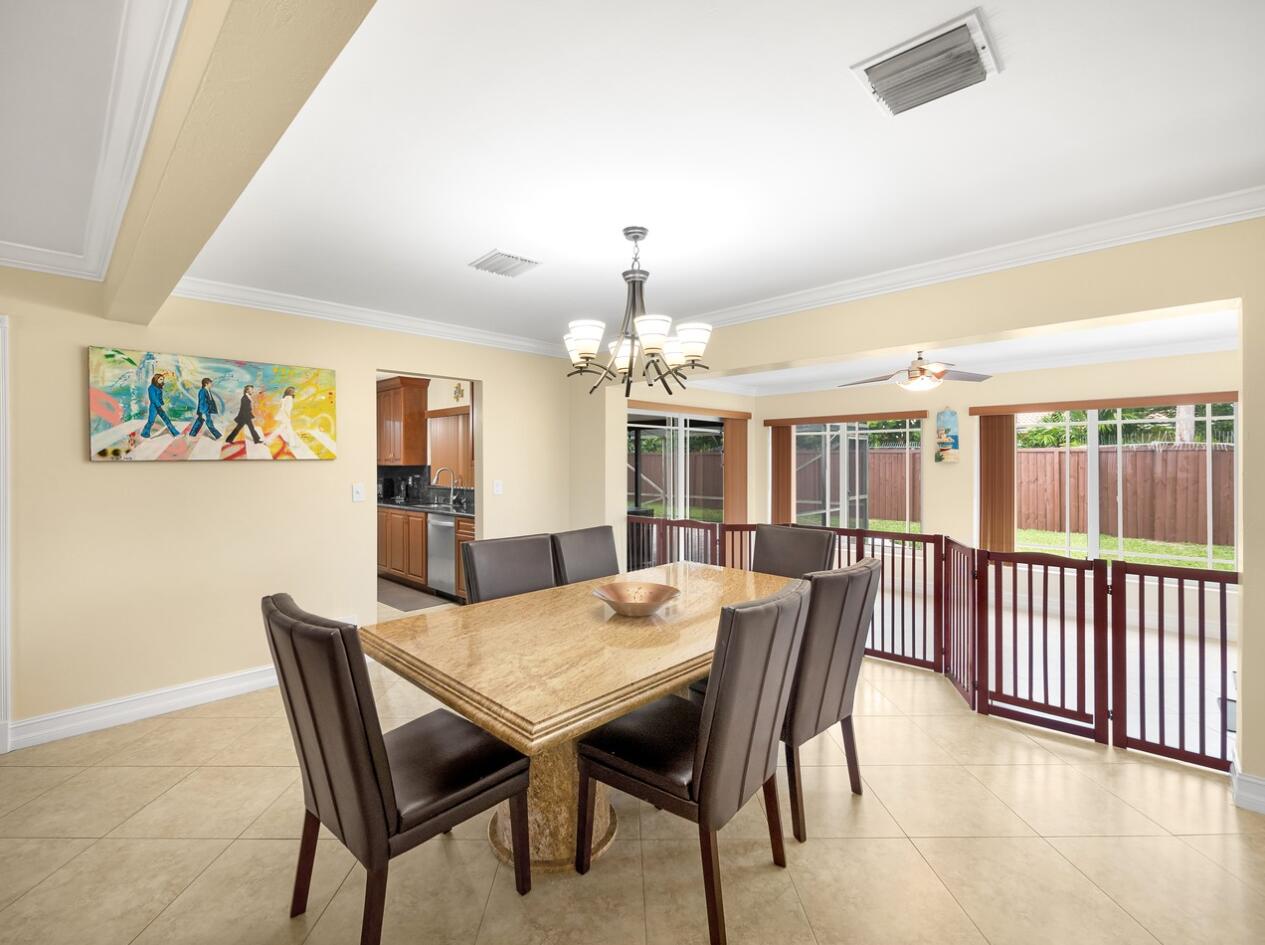 355 Northeast 24th Street Boca Raton, FL 33431 - Photo 4 of 15 a view of a dining room with furniture window and wooden floor