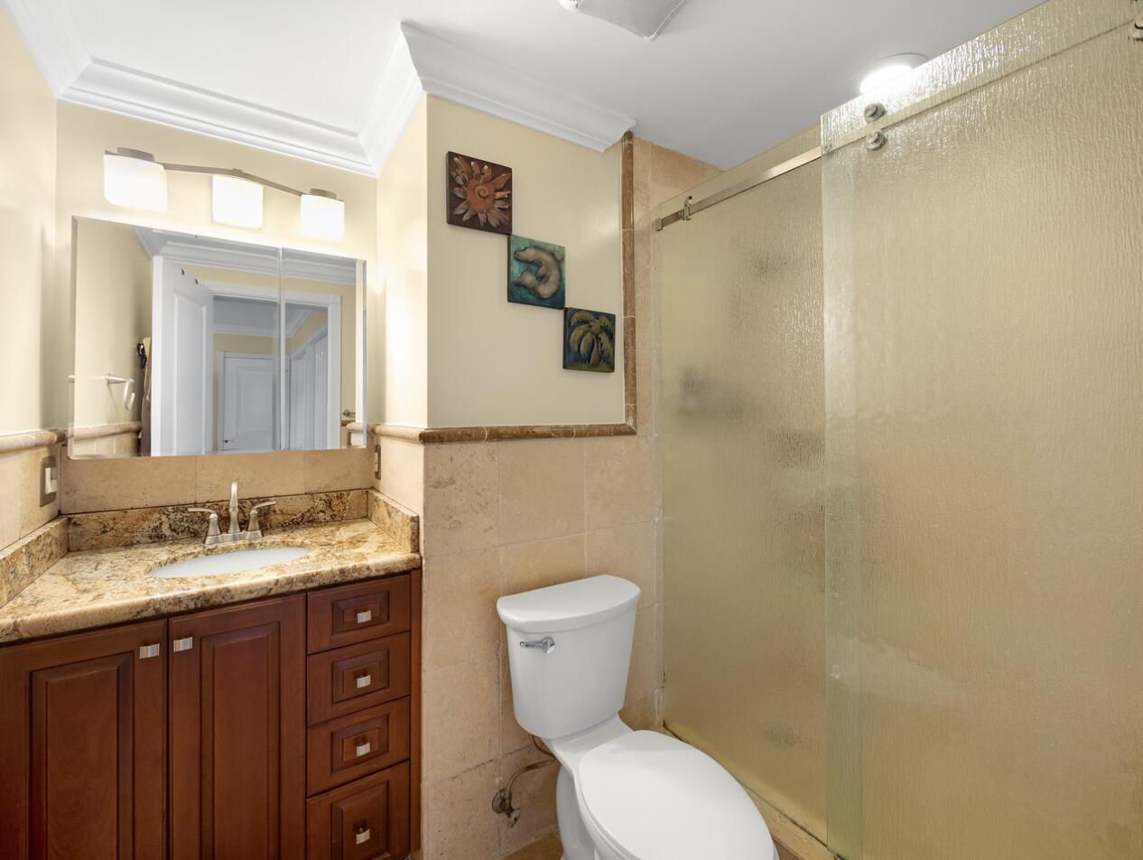 355 Northeast 24th Street Boca Raton, FL 33431 - Photo 8 of 15 a bathroom with a granite countertop toilet sink and a mirror