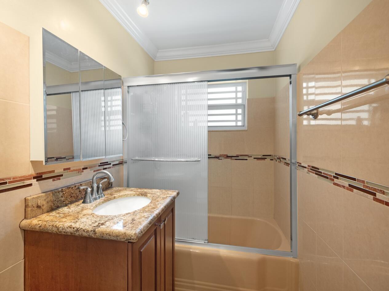 355 Northeast 24th Street Boca Raton, FL 33431 - Photo 10 of 15 a bathroom with a granite countertop sink mirror vanity and bathtub