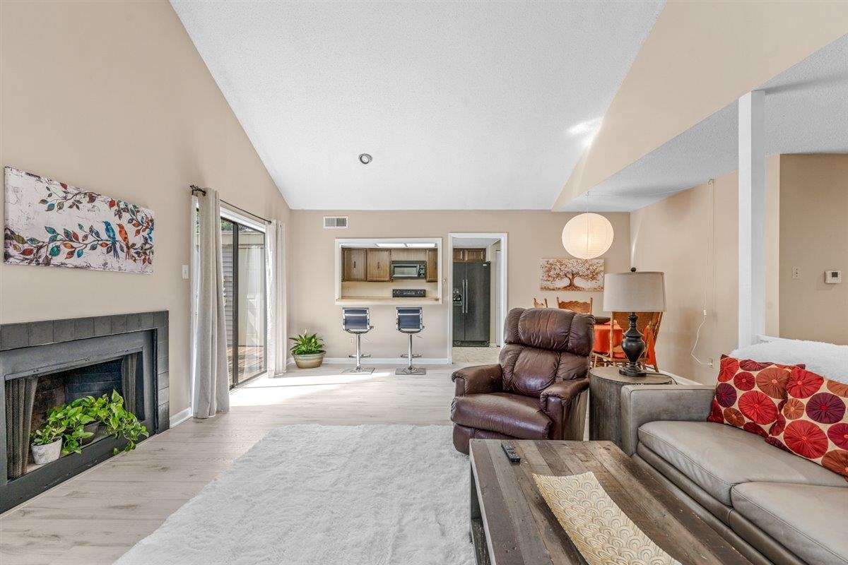 2976 Kin Cove, Unit 2976 Memphis, TN 38119 - Photo 4 of 24 Spacious living area featuring high vaulted ceilings and light wood-finish flooring