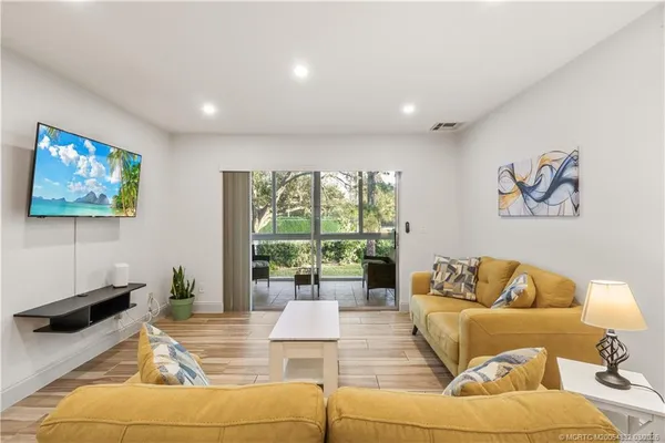 a living room with furniture and a large window