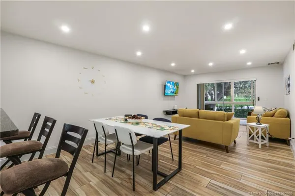 a view of a dining room with furniture window and wooden floor