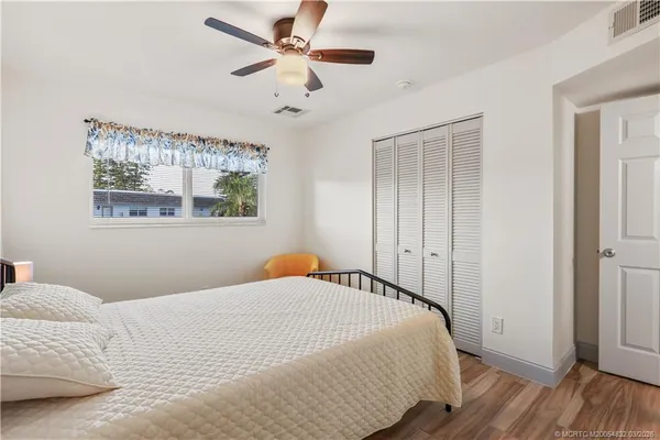 a bedroom with a large bed and a window