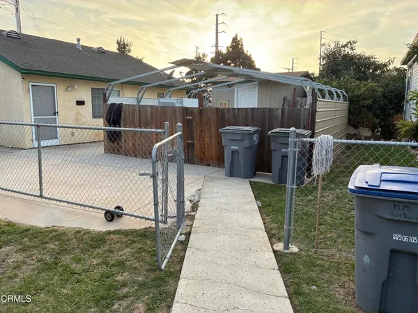 a backyard of a house with barbeque oven and outdoor seating