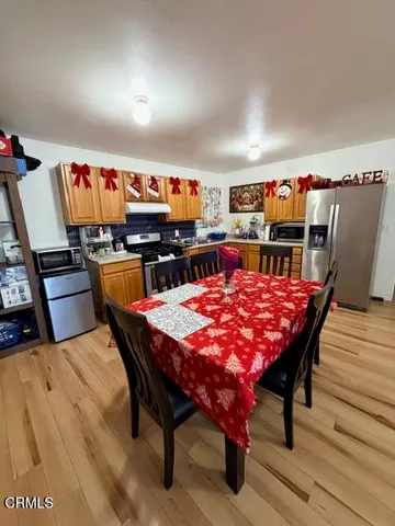 a outdoor dining space with furniture and wooden floor