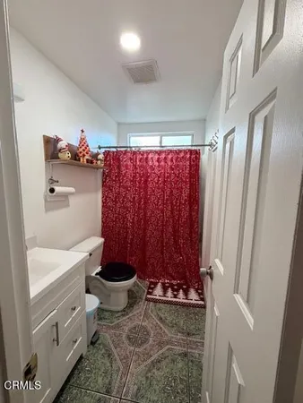 a bathroom with a toilet a sink and bathtub