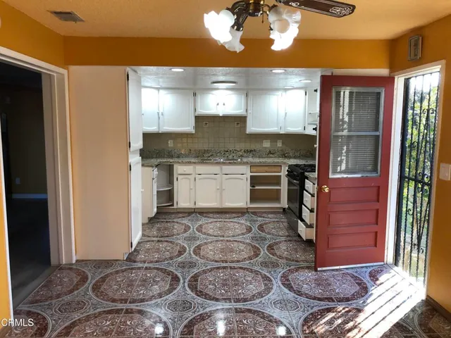 a kitchen with stainless steel appliances granite countertop a stove and a refrigerator