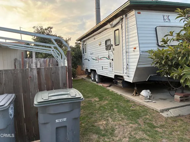 a white house covered with tall trees