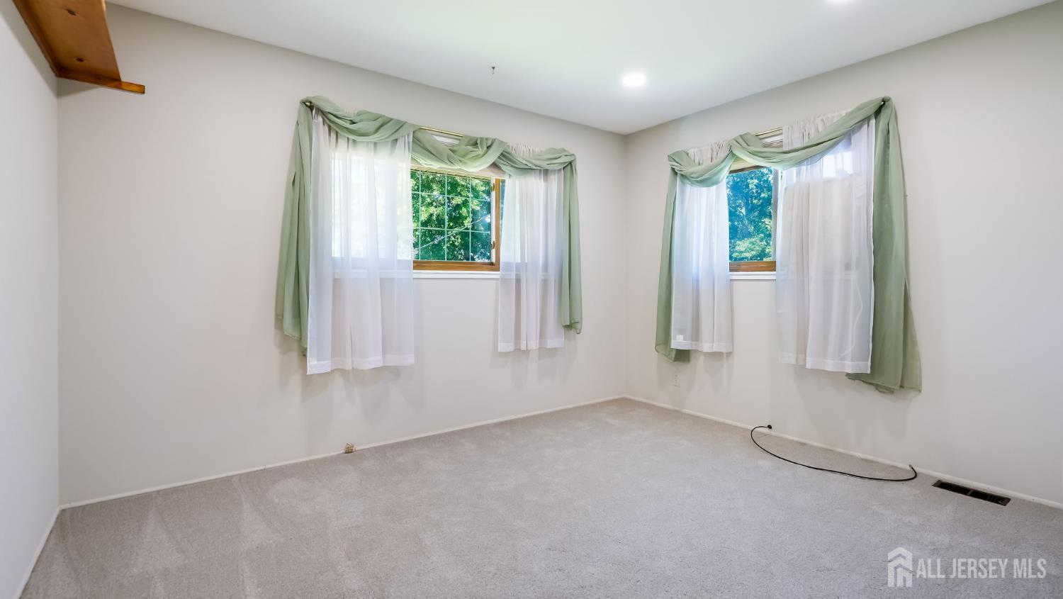 50 Sand Hills Road Kendall Park, NJ 08824 - Photo 19 of 27 an empty room with windows and closet