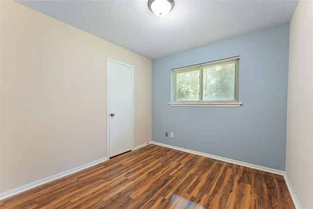a view of room with wooden floor and fan