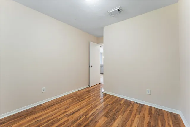 a view of room with wooden floor
