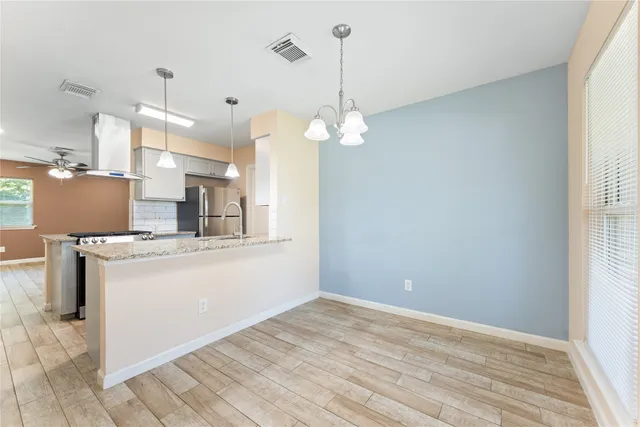 a view of a kitchen with a sink stainless steel appliances and cabinets