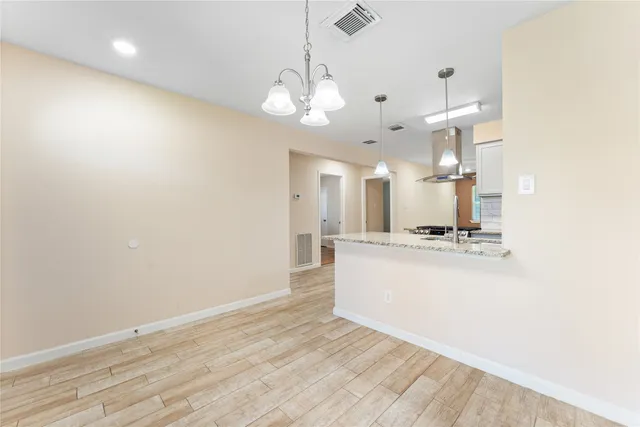 a view of a kitchen with wooden floor