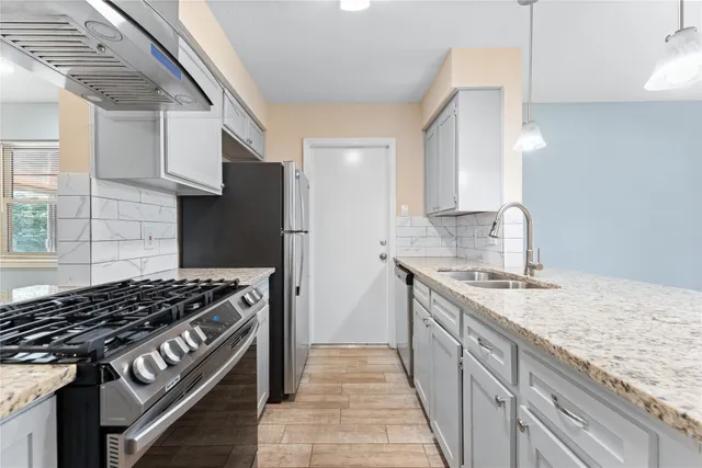 a kitchen with a stove and a sink