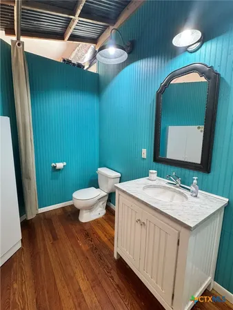 a bathroom with a toilet sink and mirror