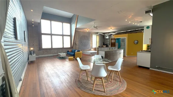a view of a dining room with furniture window and wooden floor