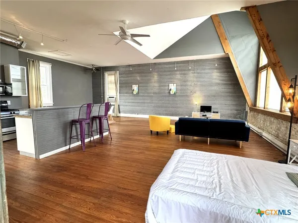 a bedroom with furniture and wooden floor