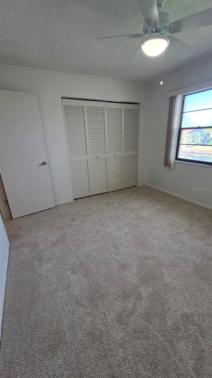 88 Boundary Boulevard, Unit 149 Rotonda West, FL 33947 - Photo 18 of 40 a view of an empty room with a window