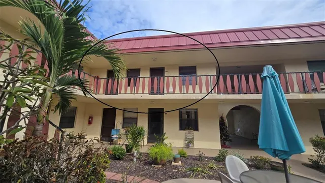 a front view of a house with balcony and a large window