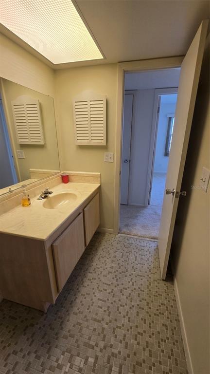 88 Boundary Boulevard, Unit 149 Rotonda West, FL 33947 - Photo 22 of 40 a bathroom with a sink a vanity and a mirror
