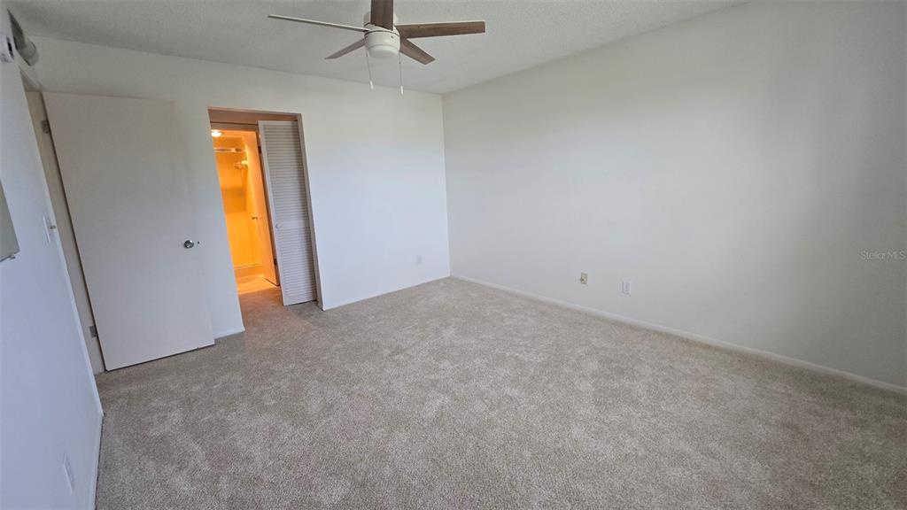 88 Boundary Boulevard, Unit 149 Rotonda West, FL 33947 - Photo 26 of 40 an empty room with a window and a ceiling fan