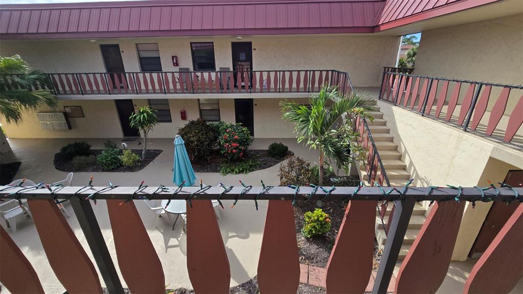 88 Boundary Boulevard, Unit 149 Rotonda West, FL 33947 - Photo 3 of 40 a front view of house with deck and outdoor seating