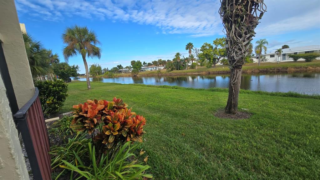 88 Boundary Boulevard, Unit 149 Rotonda West, FL 33947 - Photo 34 of 40 a front view of a house with a yard