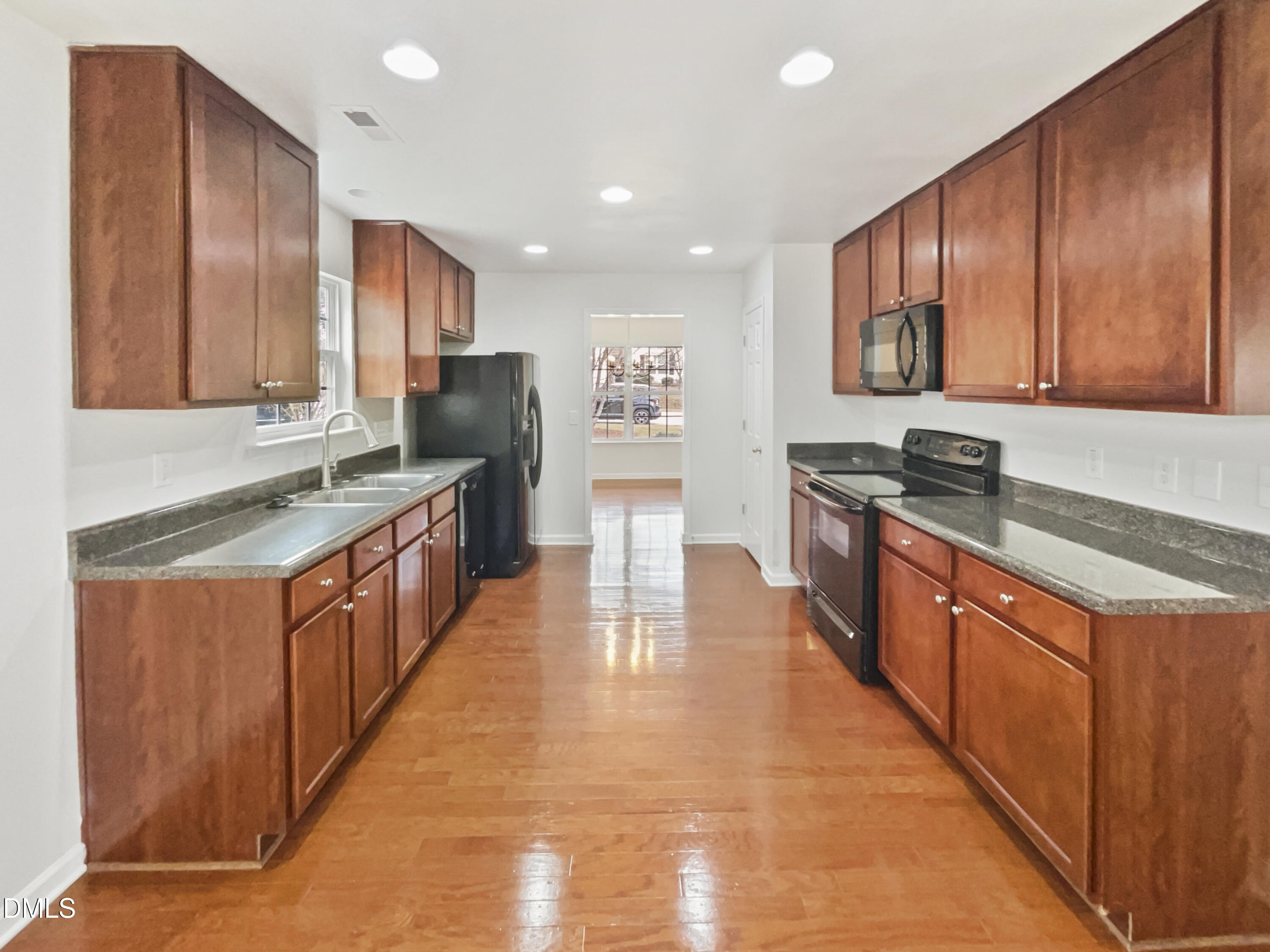 5512 Quitman Trail Raleigh, NC 27610 - Photo 3 of 18 a kitchen with stainless steel appliances granite countertop wooden cabinets a sink dishwasher a stove and a refrigerator